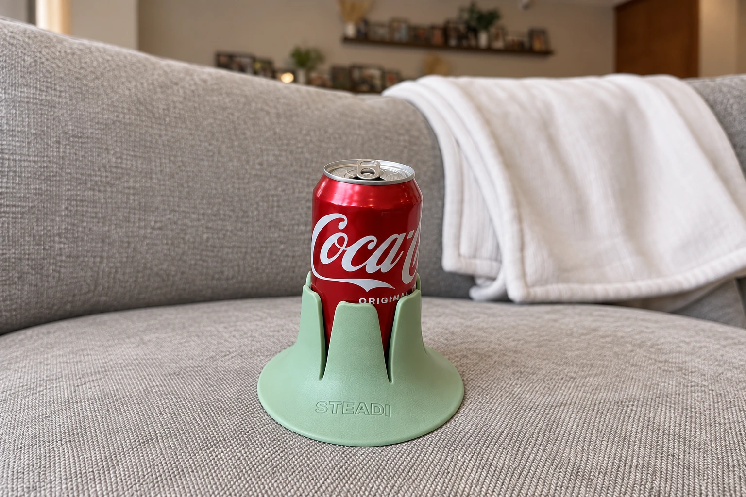 Drink in a Steadi on an apartment couch cushion, with its full base supported. AI lifestyle image.
